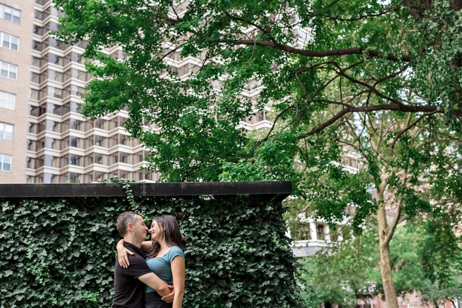 An engaged couple hold each other in Rittenhouse Square.